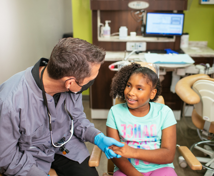 a dentist give his patient a handshake - Pediatric and Children's Dentistry in Council Bluffs, IA